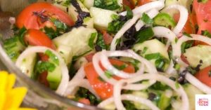 Cucumber, tomato, and mint salad in a bowl. This recipe is for a Whole30 cucumber salad.