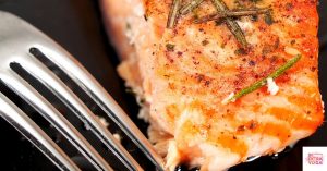 Salmon on a plate with a fork next to it. This recipe is for anti-inflammatory and dairy-free salmon.