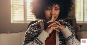 Woman in deep thought. This post discusses the difference between mindfulness and awareness.