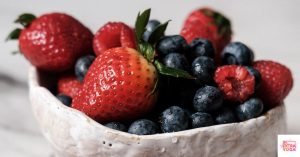 A bowl of berries in a white bowl. This article discusses the best fruits that balance hormones in females.