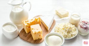 Dairy products on a table including milk and cheese. This article discusses how to reintroduce dairy after an elimination diet.
