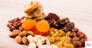 Dried fruits and nuts grouped together on a kitchen counter. This article discusses the best gut health snacks.
