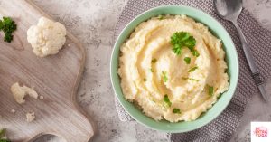 Mashed cauliflower in a teal bowl. This article shares an anti-inflammatory cauliflower recipe.