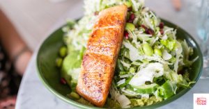 Salmon over a bed of greens. This article shares some easy anti-inflammatory lunch recipes.