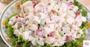 Chicken salad over lettuce on a plate. This article shares a paleo chicken salad recipe.