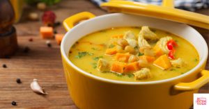 Chicken and sweet potato soup in a Dutch oven. This recipe is for paleo chicken chowder.