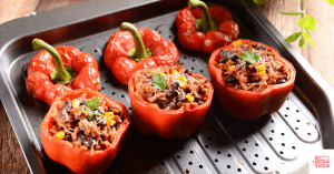 Red bell peppers stuffed with ground beef filling. This recipe is for paleo stuffed peppers.