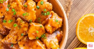 Orange chicken in a bowl. This article shares a Whole30 orange chicken recipe.