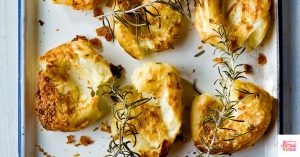 Smashed potatoes in a baking pan. This article shares a recipe for paleo smashed potatoes.