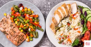 Plates with meals including salmon, veggies, chicken, and salad. This article shares recipes for hormone balancing meals.