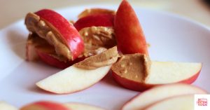 Apples slices with almond butter spread on them. This article shares hormone balancing desserts.