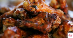 Buffalo chicken wings piled on a plate. This article shares an anti-inflammatory chicken wings recipe.